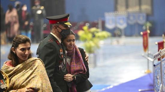 An Army officer consoles a grieving relative as they pay last respects to flag-draped caskets of the 13 victims of the Coonoor helicopter crash, at Palam airport in New Delhi on Thursday. (AP)