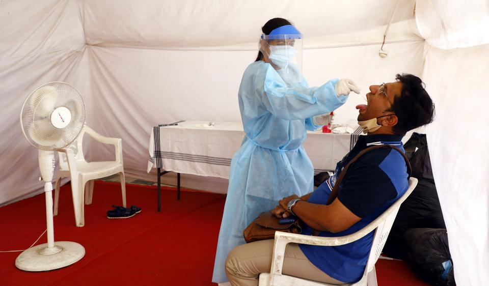 A health worker taking a swab for RT-PCR test. (Rahul Raut/HT PHOTO) A health worker taking a swab for RT-PCR test. (Rahul Raut/HT PHOTO)