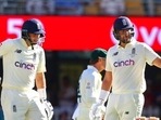 England's Dawid Malan gestures with his bat as he celebrates on reaching 50 runs as teammate Joe Root watches during day three of the first Ashes cricket test at the Gabba in Brisbane, Australia.(AP) England's Dawid Malan gestures with his bat as he celebrates on reaching 50 runs as teammate Joe Root watches during day three of the first Ashes cricket test at the Gabba in Brisbane, Australia.(AP)