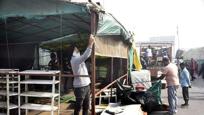 Farmers dismantle their tents and pack up the last of their belongings at the Ghazipur border near Delhi on Friday. (Sakib Ali/HT photo) Farmers dismantle their tents and pack up the last of their belongings at the Ghazipur border near Delhi on Friday. (Sakib Ali/HT photo)