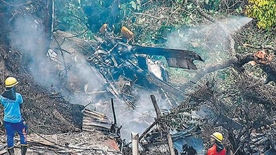 Firemen and rescue workers stand next to the debris of an Mi-17V5 helicopter crash site in Coonoor, Tamil Nadu, on Thursday. (AFP) Firemen and rescue workers stand next to the debris of an Mi-17V5 helicopter crash site in Coonoor, Tamil Nadu, on Thursday. (AFP)