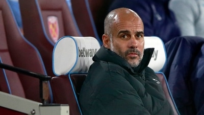 Manchester City's head coach Pep Guardiola looks out from the bench before the English League Cup fourth round soccer match between West Ham United and Manchester City, at the London Stadium, in London, Wednesday, Oct. 27, 2021. (AP)