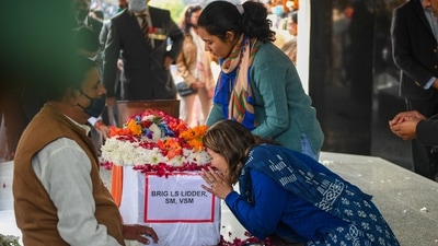 The wife and daughter of late Brigadier LS Lidder pay their last respects to him at Brar Square in Delhi. (PTI Photo) The wife and daughter of late Brigadier LS Lidder pay their last respects to him at Brar Square in Delhi. (PTI Photo)