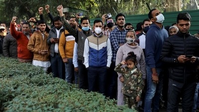 People gather outside the residence of India's chief of defence staff General Bipin Rawat to pay their respects. (Reuters)