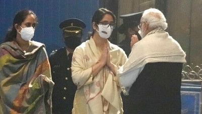 Prime Minister Narendra Modi consoles the daughters of chief of defence staff of General Bipin Rawat during the homage ceremony to the victims of the helicopter crash at Palam airport in New Delhi on Thursday. (AP) Prime Minister Narendra Modi consoles the daughters of chief of defence staff of General Bipin Rawat during the homage ceremony to the victims of the helicopter crash at Palam airport in New Delhi on Thursday. (AP)