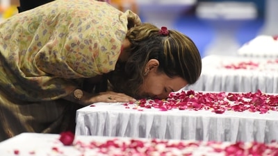 A family member of Brigadier LS Lidder pays homage to the coffin containing his mortal remains during a wreath-laying ceremony at Palam Airport in New Delhi. (PTI) A family member of Brigadier LS Lidder pays homage to the coffin containing his mortal remains during a wreath-laying ceremony at Palam Airport in New Delhi. (PTI)