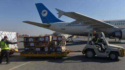 Airport staff prepare to transport a shipment of Covid-19 vaccines at the Kabul airport on December 8, 2021. (AFP) Airport staff prepare to transport a shipment of Covid-19 vaccines at the Kabul airport on December 8, 2021. (AFP)