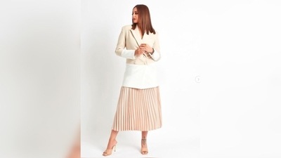 For the event, Sonakshi Sinha opted for a beige and white long blazer which she teamed with a beige pleated skirt. (Instagram/@aslisona)