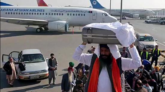 Kabul, Dec 10 (ANI): A Sikh delegation with the Holy book of Guru Granth Sahib boarding a plane for India from Afghanistan under Operation Devi Shakti, in Kabul on Friday. (ANI Photo) (ANI)