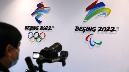 A reporter films logos of Beijing 2022 Winter Olympics at an exhibition room(REUTERS)