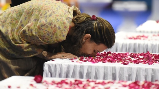 A family member of Brigadier LS Lidder pays homage to the coffin containing his mortal remains during a wreath-laying ceremony at Palam Airport in New Delhi.(PTI)