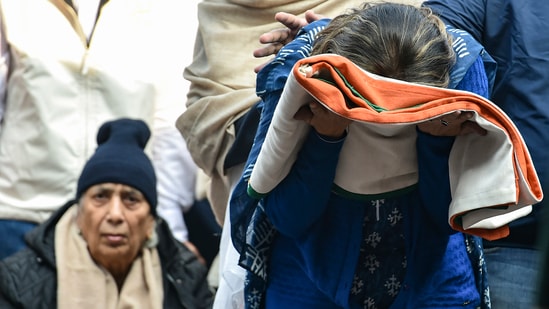 Wife of late Brigadier LS Lidder received the Tricolour as she and others pay last respects to her husband during his funeral at Brar Square, Delhi Cantt, in New Delhi.(PTI)