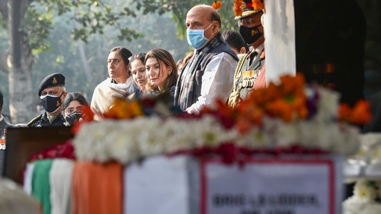 Union defence minister Rajnath Singh and Brigadier LS Lidder's wife and daughter pay their last respects to him during his funeral at Brar Square, Delhi Cantt, in New Delhi.(PTI)