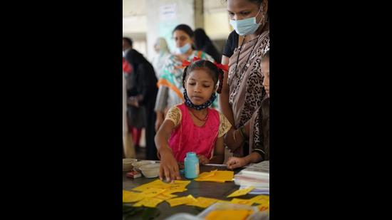 A teacher helps a child at the programme to bring back dropouts from schools in Thane. The programme was funded by UNICEF and conducted by several NGOs. (HT PHOTO)