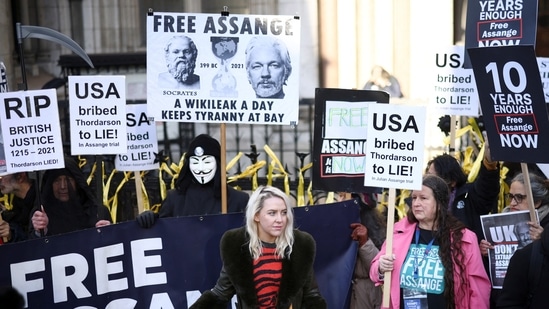 Supporters of Julian Assange display signs and banners, outside the Royal Courts of Justice in London, Britain.(Reuters)