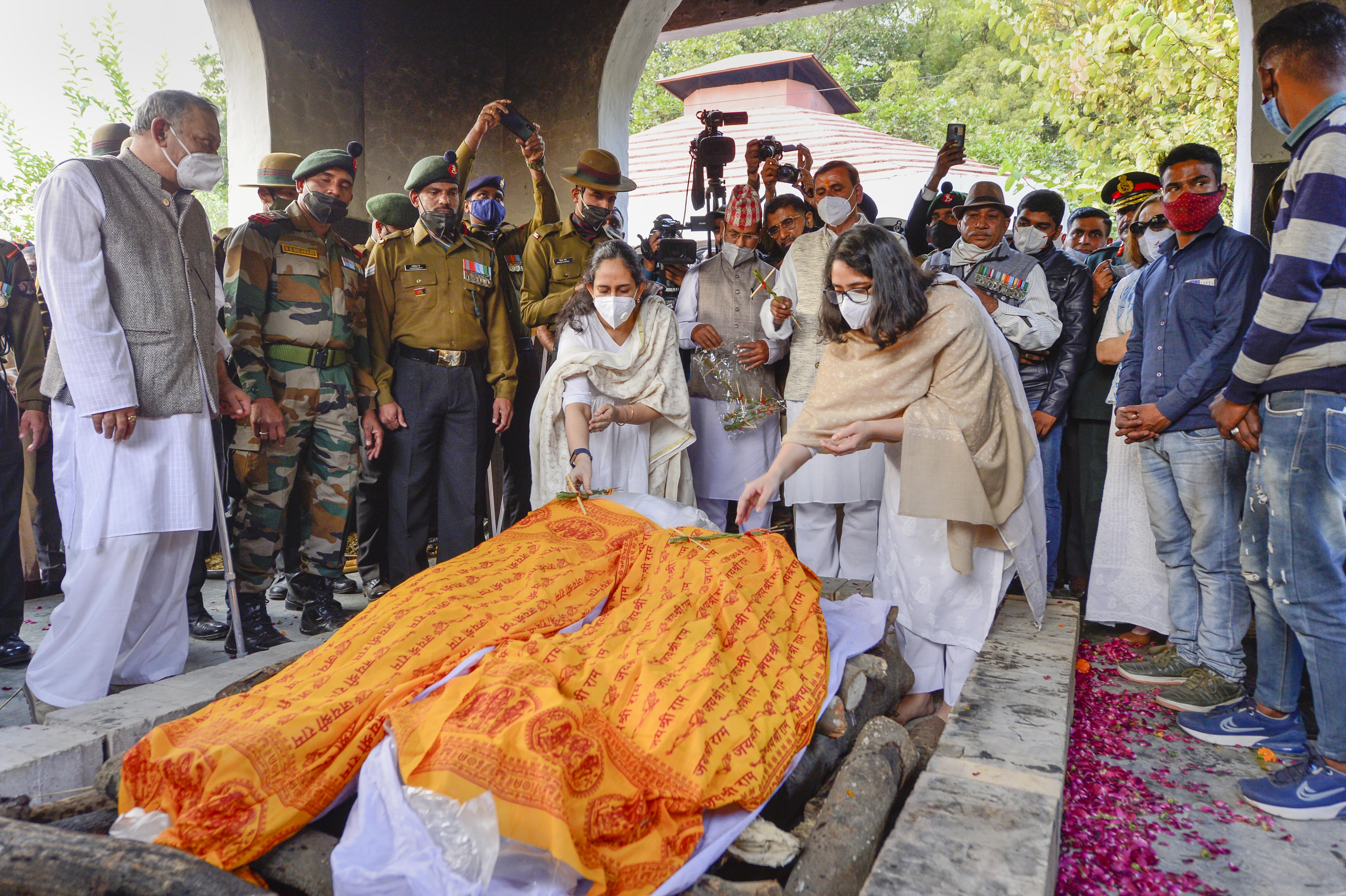 Kritika and Tarini, daughters of late Chief of Defence Staff (CDS) Gen Bipin Rawat and Madhulika Rawat, during the cremation of their parents at Brar Square crematorium, in New Delhi, Friday, Dec. 10, 2021. General Rawat was killed along with his wife and 11 armed forces personnel in an Indian Air Force (IAF) helicopter crash near Coonoor in Tamil Nadu on Wednesday. (PTI) Kritika and Tarini, daughters of late Chief of Defence Staff (CDS) Gen Bipin Rawat and Madhulika Rawat, during the cremation of their parents at Brar Square crematorium, in New Delhi, Friday, Dec. 10, 2021. General Rawat was killed along with his wife and 11 armed forces personnel in an Indian Air Force (IAF) helicopter crash near Coonoor in Tamil Nadu on Wednesday. (PTI)