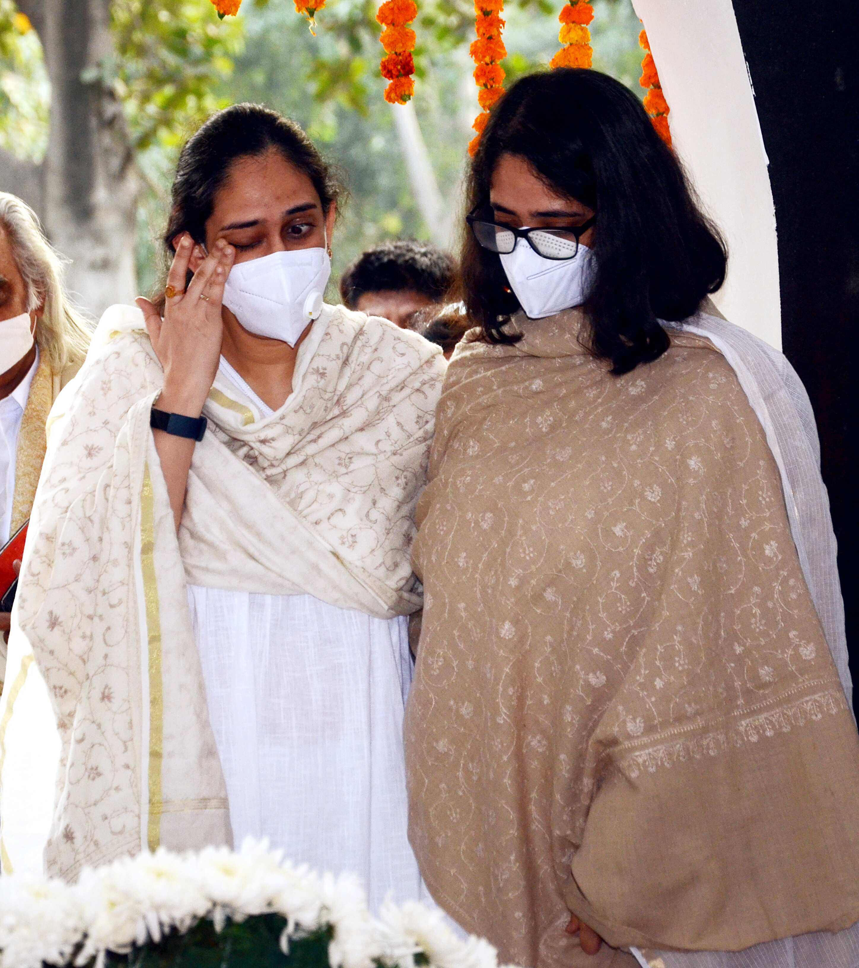 Daughters of CDS General Bipin Rawat and his wife Madhulika Rawat, who died in IAF helicopter crash in Tamil Nadu, mourns during their cremation, at the Brar Square crematorium in New Delhi on Friday, December 10, 2021. (ANI Photo/Sanjay Sharma) Daughters of CDS General Bipin Rawat and his wife Madhulika Rawat, who died in IAF helicopter crash in Tamil Nadu, mourns during their cremation, at the Brar Square crematorium in New Delhi on Friday, December 10, 2021. (ANI Photo/Sanjay Sharma)
