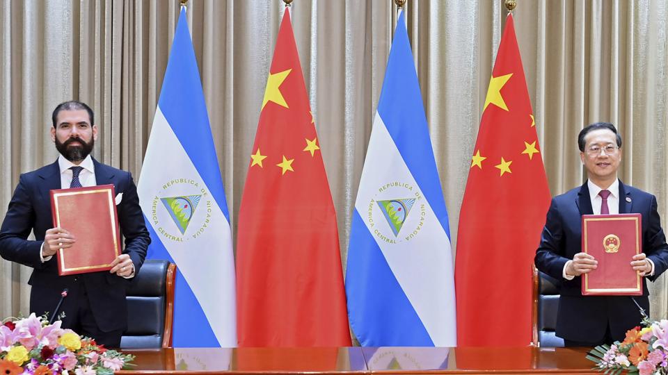 Laureano Ortega Murillo, son of and advisor to Nicaraguan President Daniel Ortega (left) and Chinese vice foreign minister Ma Zhaoxu sign a communique on the resumption of diplomatic relations between the two countries in northern China’s Tianjin Municipality on Friday. (AP)