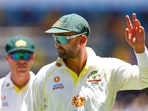 Australia's Nathan Lyon salutes to the crowd after claiming his 400th wicket, dismissing England's Dawid Malan for 82, during day four of the first Ashes cricket Test match between England and Australia at the Gabba in Brisbane on December 11, 2021. (Photo by Patrick HAMILTON / AFP) / -- IMAGE RESTRICTED TO EDITORIAL USE - STRICTLY NO COMMERCIAL USE --(AFP)