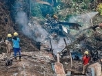 Firemen and rescue workers stand next to the debris of an IAF Mi-17V5 helicopter crash site in Coonoor, (AFP File Photo) Firemen and rescue workers stand next to the debris of an IAF Mi-17V5 helicopter crash site in Coonoor, (AFP File Photo)