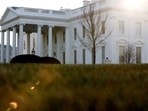 A general view of the sun rising behind the White House in Washington.