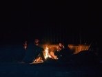 People warm themselves around a bonfire on a cold winter evening at NIzamuddin in New Delhi. People warm themselves around a bonfire on a cold winter evening at NIzamuddin in New Delhi.
