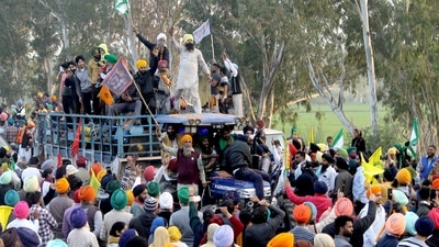 Farmers celebrate on the road while returning from Delhi after calling off a protest against three farm laws and other issues at Shambhu Border, in Patiala on Saturday. (Harmeet Sodhi) Farmers celebrate on the road while returning from Delhi after calling off a protest against three farm laws and other issues at Shambhu Border, in Patiala on Saturday. (Harmeet Sodhi)