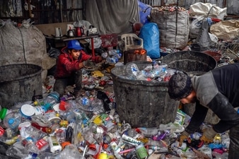 Afghan refugees collect waste at a dumping ground in Istanbul. (AFP) Afghan refugees collect waste at a dumping ground in Istanbul. (AFP)