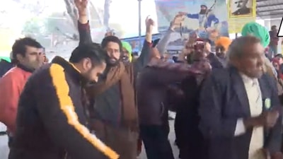 Farmers seen celebrate at Tikri border as they set off for their homes following a year-long protest. (ANI video grab) Farmers seen celebrate at Tikri border as they set off for their homes following a year-long protest. (ANI video grab)