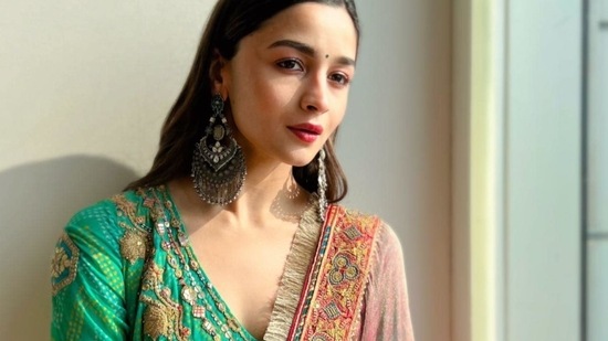 It was layered with a contrasting sheer pink dupatta that was lined with beautiful kiran lace and a multicoloured broad border lining the dupatta. The ensemble is credited to Indian fashion label Rimple &amp; Harpreet Narula.(Instagram/aliaabhatt)