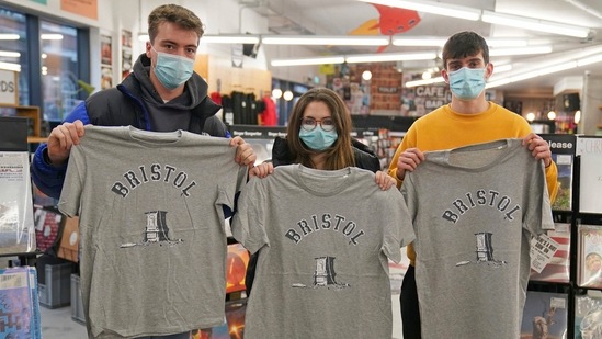 People lined up Saturday in the English city of Bristol to get the latest work by elusive street artist Banksy — a T-shirt created to help four defendants charged over the toppling of a local statue of a slave trader.(AP)