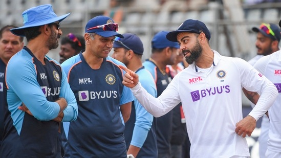 Mumbai: Indian team captain Virat Kohli with head coach Rahul Dravid after their victory in the 2-match test cricket series against New Zealand, at Wankhede stadium in Mumbai.(PTI)