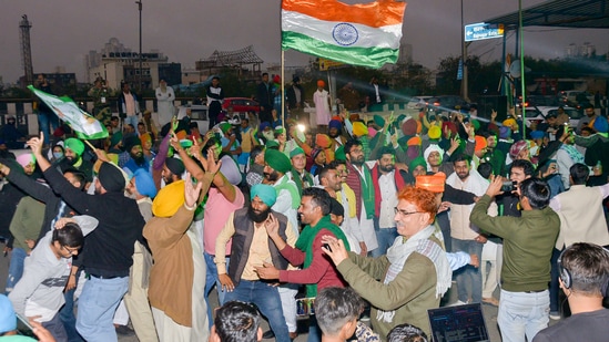 Farmers dance as they celebrate at the Ghazipur border after a decision to withdraw farmers-movement in the wake of the government accepting all demands put forward by the agitating farmers.(PTI)