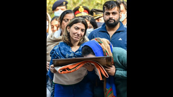 Wife and daughter of the late Brigadier LS Lidder break down while receiving the national flag that was wrapped around Lidder's mortal remains, before his last rites, at Brar Square, Delhi Cantt, in New Delhi on Friday. (PTI PHOTO.)