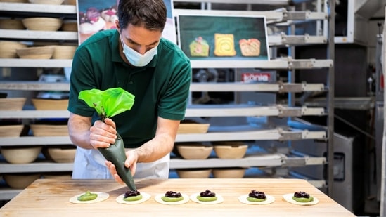 Baker Gerboin layers fruit paste over pureed algae to create a dessert in his Munich bakery.(Photo: Lukas Barth, Reuters)