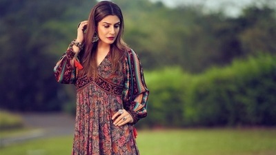 She completed her attire with a pair of brown block heels from Eridani and amplified the glam quotient with a dab of maroon lipstick, highlighted cheeks, kohl-lined eyes, mascara laden eyelashes and filled-in eyebrows. (Instagram/officialraveenatandon) She completed her attire with a pair of brown block heels from Eridani and amplified the glam quotient with a dab of maroon lipstick, highlighted cheeks, kohl-lined eyes, mascara laden eyelashes and filled-in eyebrows. (Instagram/officialraveenatandon)