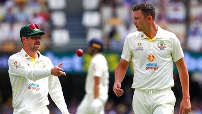 Australia's Travis Head (left) passes the ball to teammate Josh Hazlewood during day 3 of the first Ashes cricket Test. (AP) Australia's Travis Head (left) passes the ball to teammate Josh Hazlewood during day 3 of the first Ashes cricket Test. (AP)