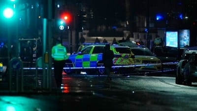 Police attend the scene near Kensington High Street in London. (AP)