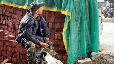 Stopping by a pile of bricks, Mr Kumar gives a sense of his previous life.