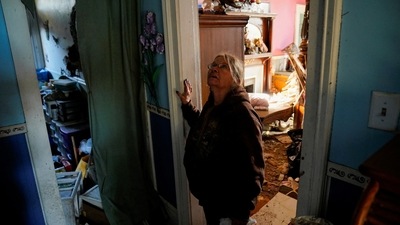 A women inspects the damage of her home in the hallway where she survived the storm after a devastating outbreak of tornadoes ripped through several U.S. states, in Mayfield, Kentucky, United States on December 11.&nbsp; (REUTERS)