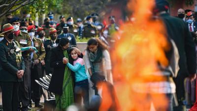 Family members of Lt Colonel Harjinder Singh, who died in the Coonoor chopper crash, perform his last rites at Brar Square in New Delhi on Sunday. (PTI)