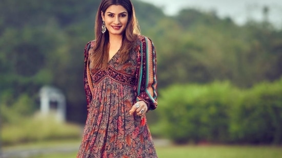 Taking to her social media handle, Raveena shared a slew of pictures featuring her in a full sleeves multicoloured midi dress that came with a deep V-neckline to add to the oomph factor and extended into a pleated skirt below.(Instagram/officialraveenatandon)