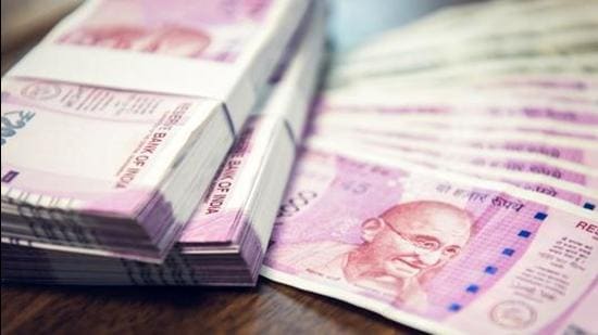 Indian Rupee money stacks and banknotes on the table , closed up shot (Shutterstock)