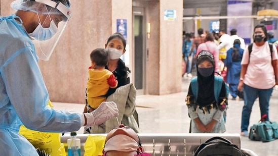 A health care worker collects a swab sample of a passenger for a Covid-19 test at Bandra terminal in Mumbai on Sunday.(Vijay Bate/HT) A health care worker collects a swab sample of a passenger for a Covid-19 test at Bandra terminal in Mumbai on Sunday.(Vijay Bate/HT)