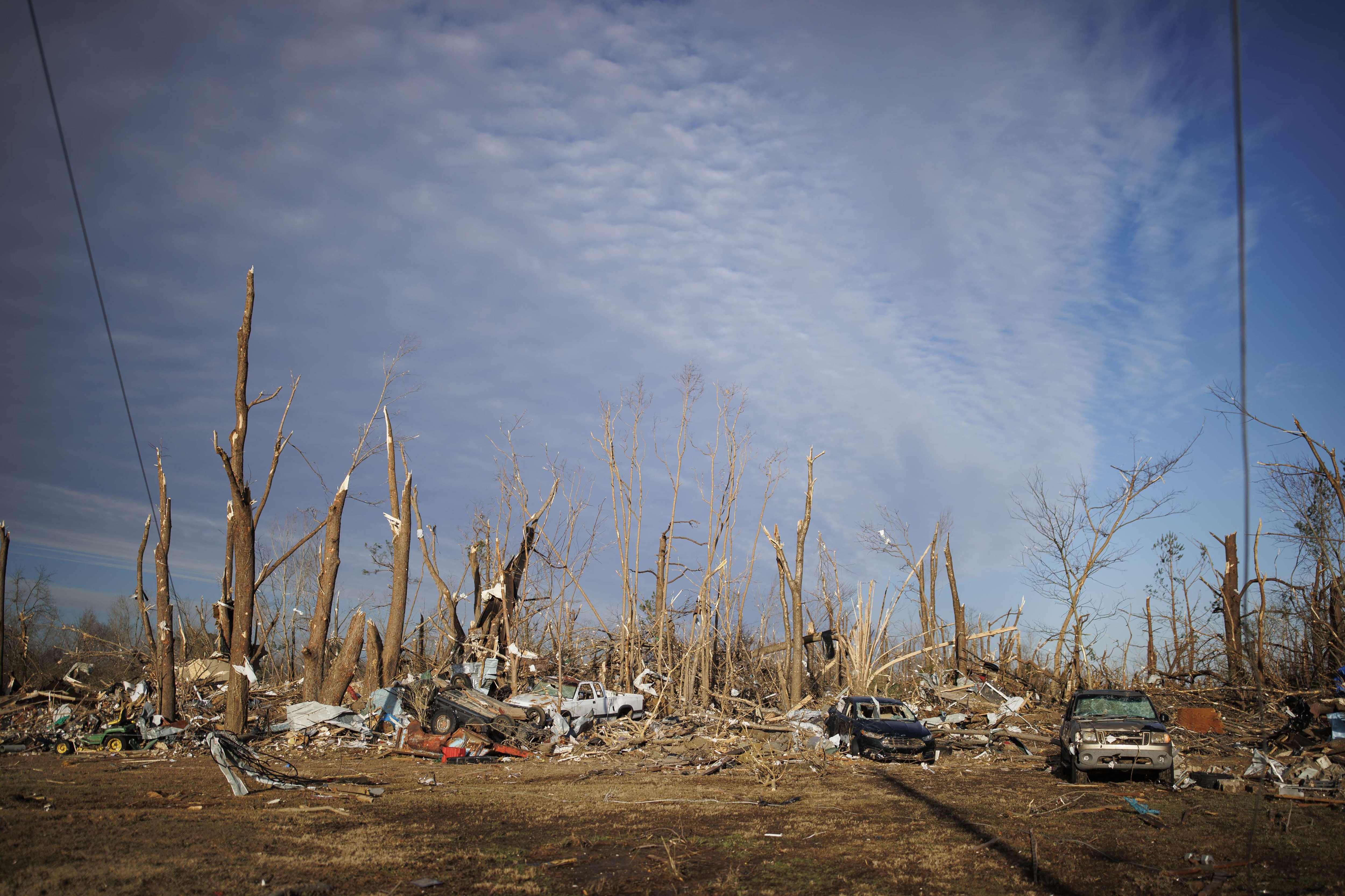 Cars lay scattered in a neighborhood almost completely decimated after a tornado ripped through the area the previous evening on December 11, 2021 in Mayfield, Kentucky. (AFP)