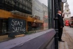 A sign reading 'stay safe' is placed at a shop window of a cafe in an empty street in the financial district, known as The City, in London(AP Photo) A sign reading 'stay safe' is placed at a shop window of a cafe in an empty street in the financial district, known as The City, in London(AP Photo)