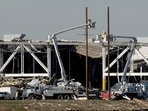 Amazon crew on lifts document the damage from the tornado that hit an Amazon distribution centre where the roof collapsed in Edwardsville, Illinois