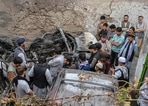 Afghan residents and family members of the victims gather next to a damaged vehicle inside a house, day after a US drone airstrike in Kabul. Afghan residents and family members of the victims gather next to a damaged vehicle inside a house, day after a US drone airstrike in Kabul.