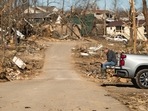 A resident amid destroyed homes following a tornado in Cambridge Shores, Kentucky, US. A resident amid destroyed homes following a tornado in Cambridge Shores, Kentucky, US. 