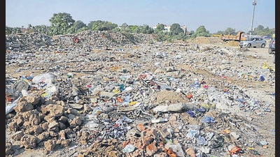 Garbage dumped on one of the vacant plots in Sector 45. (Keshav Singh/HT)